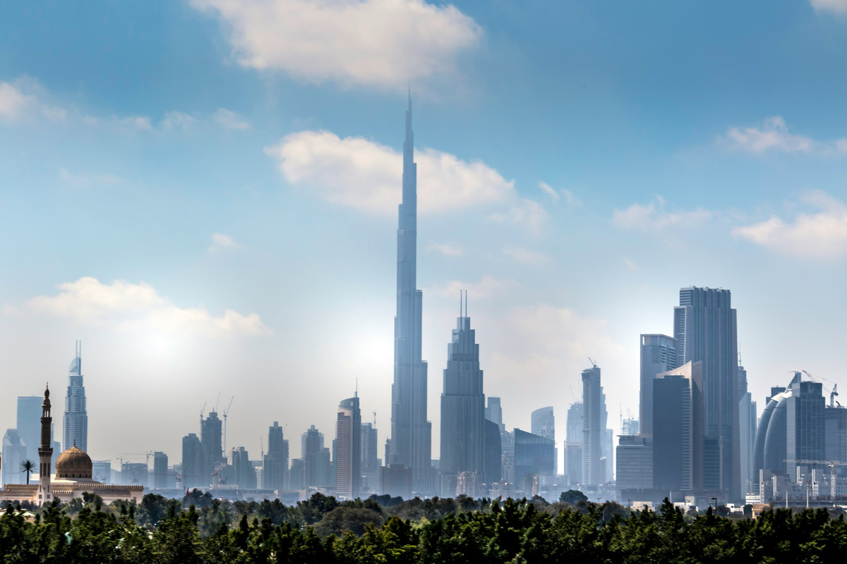 Sheikh Zayed road and Burj Khalifa skyline on a moderately cloudy day.